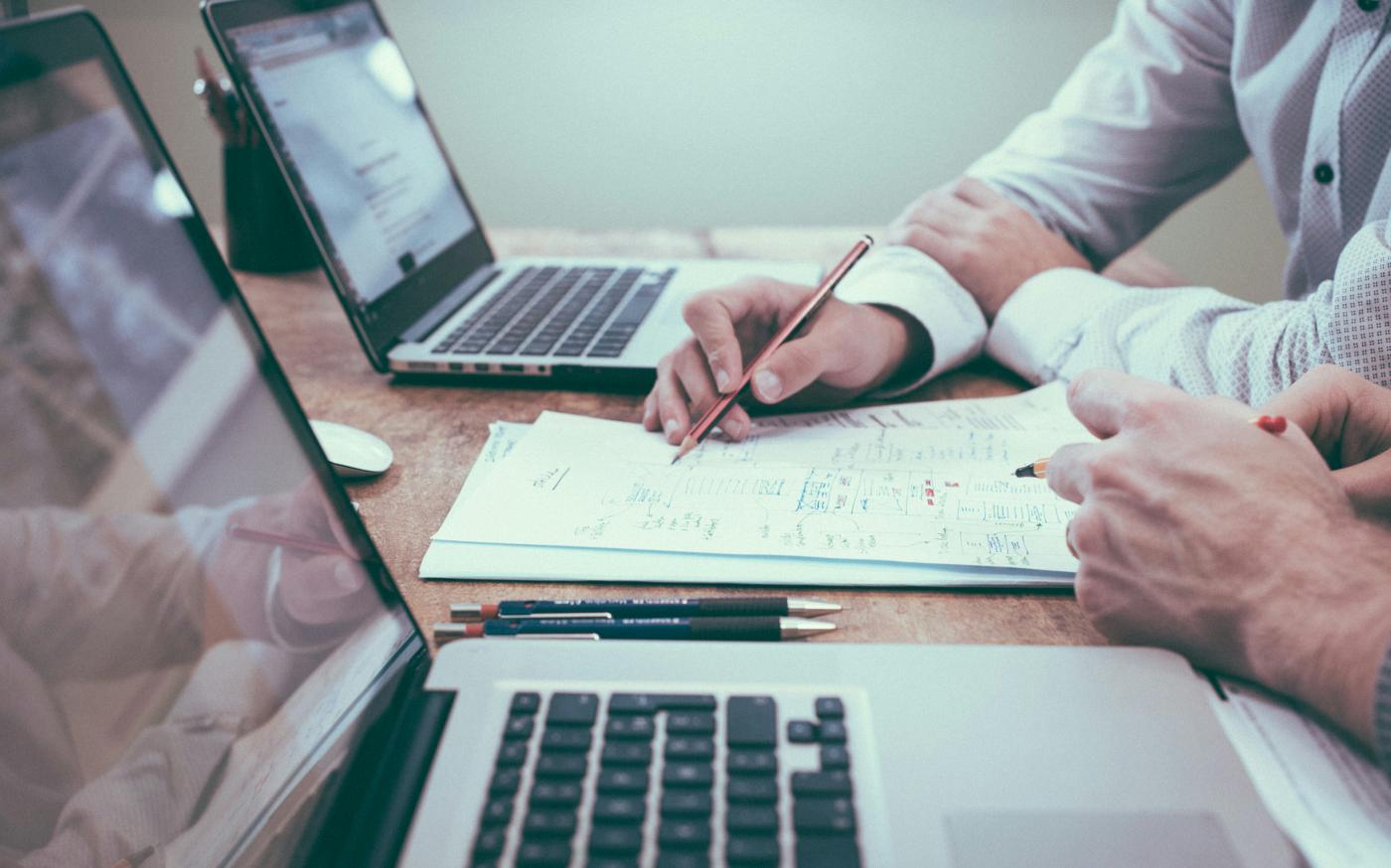 person holding pencil near laptop computer by Scott Graham courtesy of Unsplash.