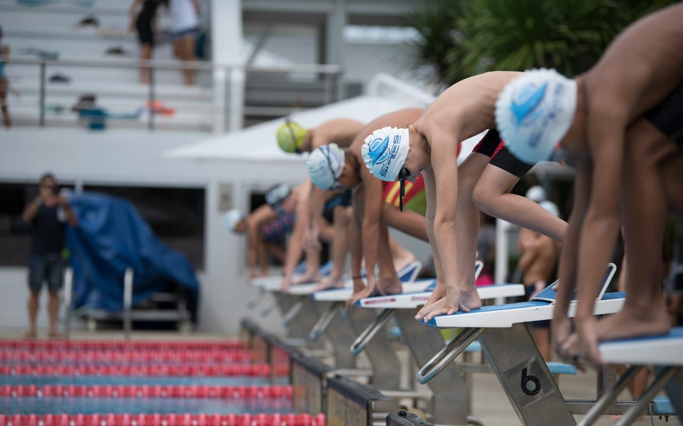 group of men attending on swimming competition by Arisa Chattasa courtesy of Unsplash.