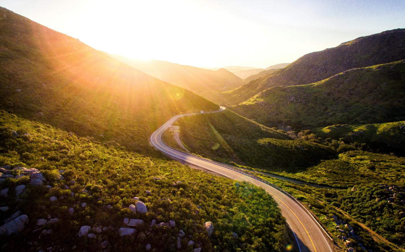 mountain pass during sunrise by Matt Howard courtesy of Unsplash.