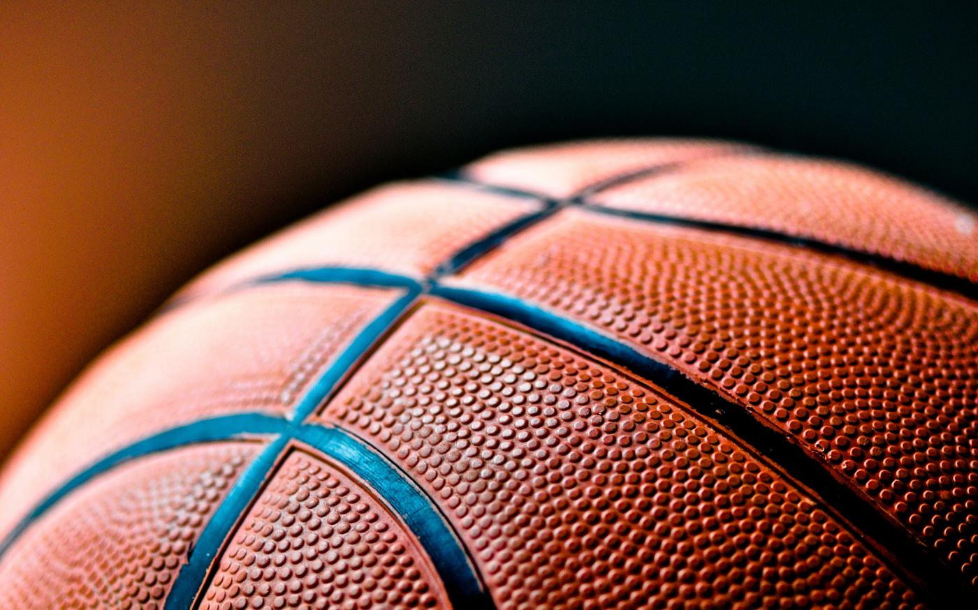 brown and black basketball ball by Kylie Osullivan courtesy of Unsplash.