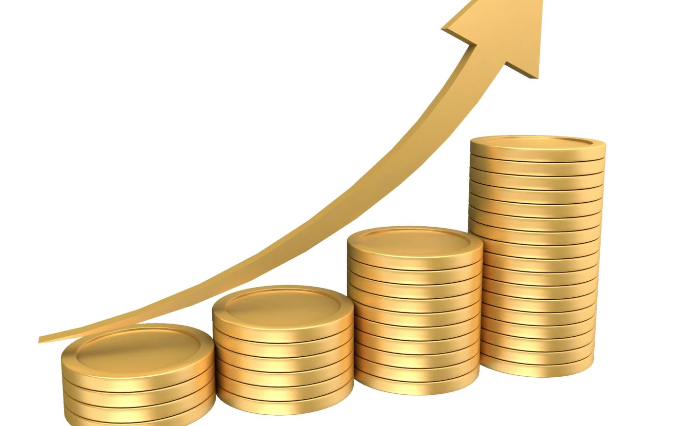 Stacks of gold coins with an upward trending arrow by Eyestetix Studio courtesy of Unsplash.