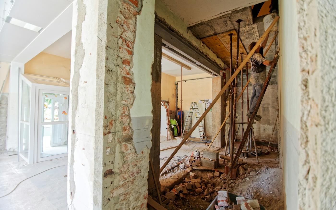 man climbing on ladder inside room by Milivoj Kuhar courtesy of Unsplash.