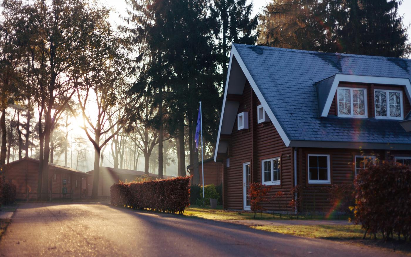 brown and red house near trees by Rowan Heuvel courtesy of Unsplash.