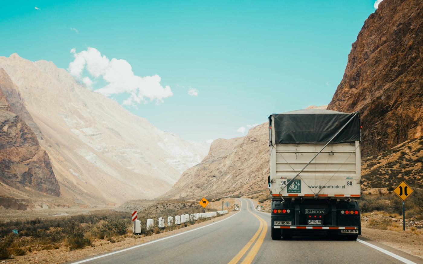white and black truck near mountain at daytime by Rodrigo Abreu courtesy of Unsplash.