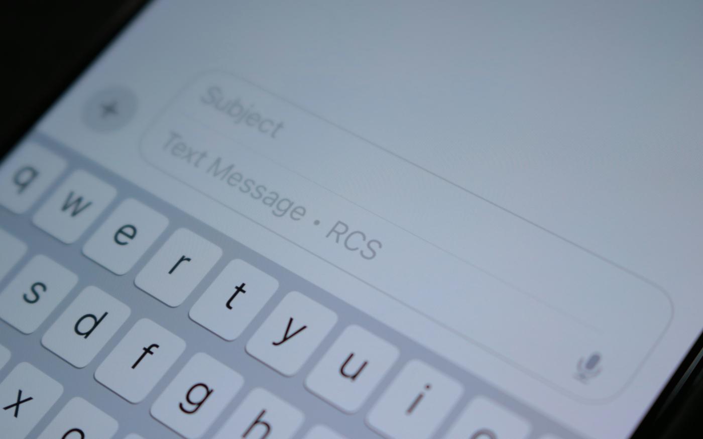 A close up of a cell phone with a keyboard by Samuel Angor courtesy of Unsplash.