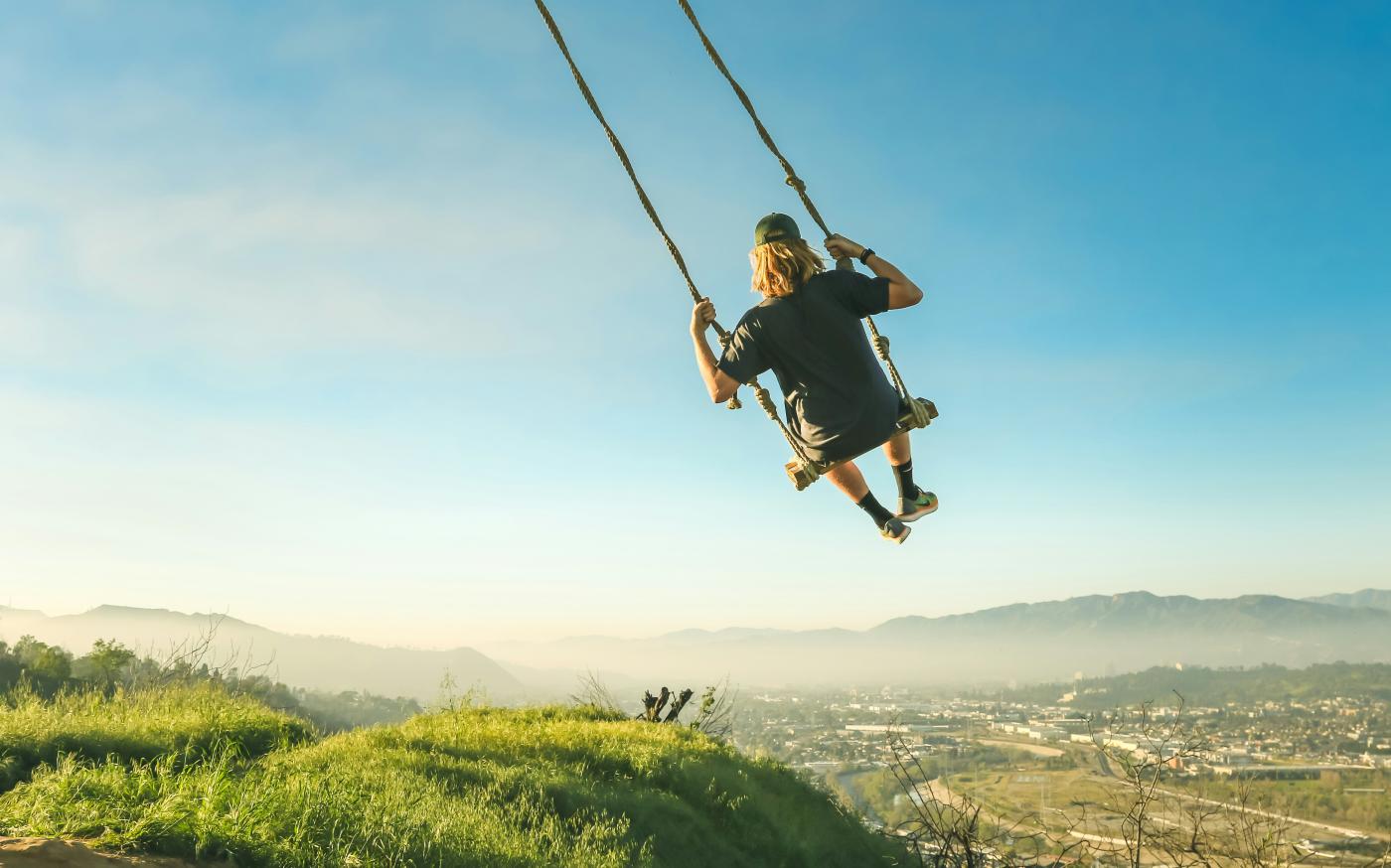 women riding swing by Jeremy Bishop courtesy of Unsplash.
