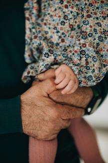 a close up of a person holding a baby by serjan midili courtesy of Unsplash.