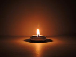 round ceramic bowl with lighted candle by CHIRAG K courtesy of Unsplash.