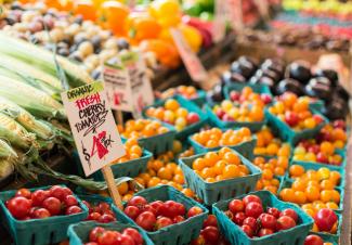 red tomato lot on blue baskets by Anne Preble courtesy of Unsplash.