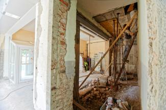 man climbing on ladder inside room by Milivoj Kuhar courtesy of Unsplash.