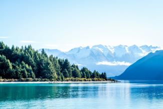 lake surrounded by trees and mountain during daytime by Photoholgic courtesy of Unsplash.