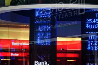 a bank sign in front of a building by Oren Elbaz courtesy of Unsplash.