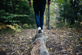 man walking on forest by Jon Flobrant courtesy of Unsplash.
