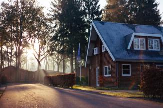 brown and red house near trees by Rowan Heuvel courtesy of Unsplash.