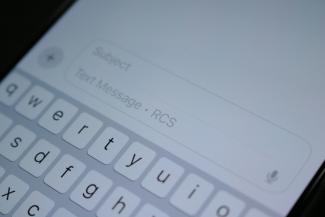 A close up of a cell phone with a keyboard by Samuel Angor courtesy of Unsplash.