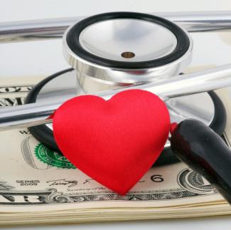 a stethoscope and a heart on top of money by Marek Studzinski courtesy of Unsplash.