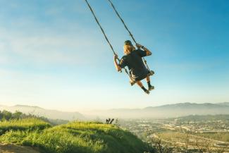 women riding swing by Jeremy Bishop courtesy of Unsplash.